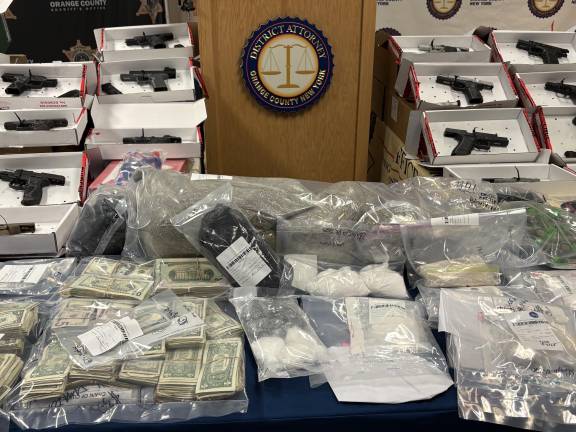 Guns, drugs and money confiscated as part of Operation Powder Burn.