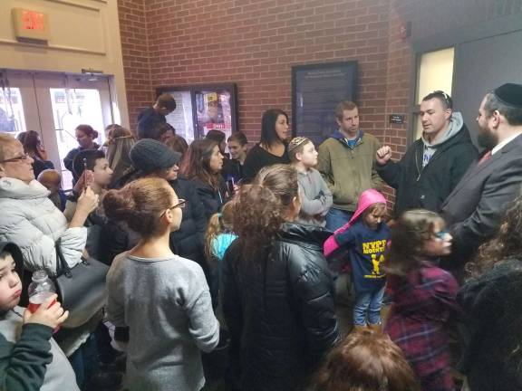 Officer John Loftus of Monroe, (second from right), a Bronx police officer speaks to Chabad Hebrew School students about his experience as an officer. His 5-year-old daughter, Juliana, attends Chabad Hebrew School.