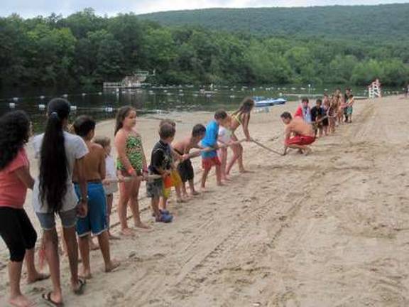 Lifeguards organized a tug-of-war at the water's edge.