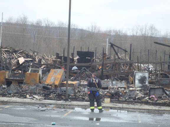 The remains of the Mid-State Lumber warehouse on Friday afternoon. Photo by Nathan Mayberg