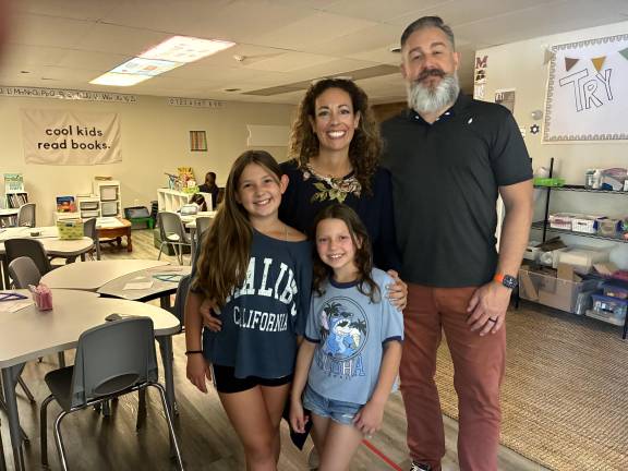 Roots &amp; Wings Founders Jenny and Burton Mills with their daughter Talula, 10 (left) and another student.