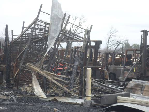 The remains of the Mid-State Lumber warehouse on Friday afternoon. Photo by Nathan Mayberg
