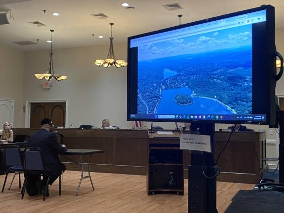 Joel Mann, the owner of a highly-discussed parcel of land on Round Lake, answers questions at the Aug. 10 Monroe Town Board meeting
