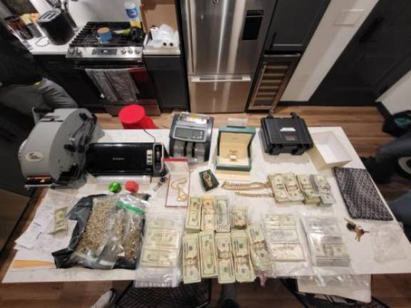 In addition to the drugs and guns, police seized an undisclosed amount of cash.