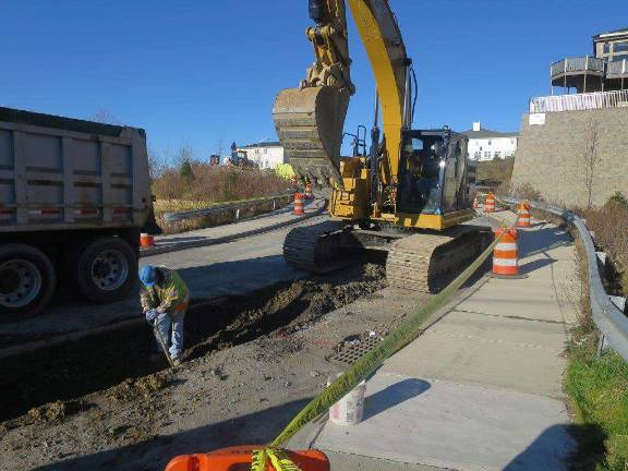 A back hoe operator digs the latest section of the pipeline path that will bring water from Mountainville into Kiryas Joel by June.