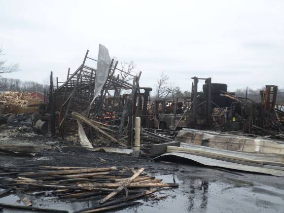 The remains of the Mid-State Lumber warehouse on Friday afternoon. Photo by Nathan Mayberg