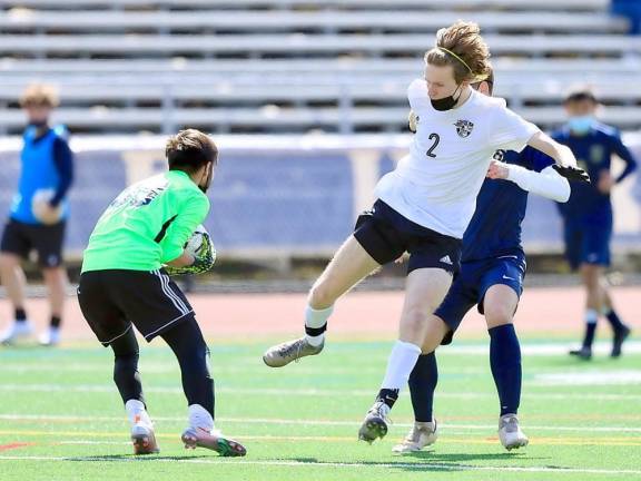 Crusader (#2) Eric Shippee arrives just a second too late as the Goldback goalie secures the ball.