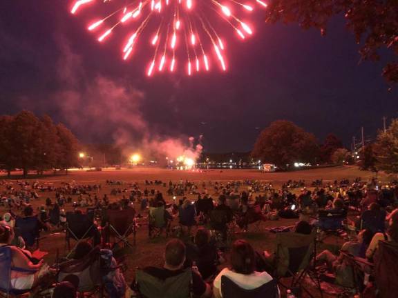 The Monroe crowd illuminated by fireworks