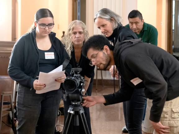 Marina Cilento of Carmel, N.Y., a sophomore Digital Media Production student (left), helps to film the oral history of four Maryknoll Sisters at the congregation’s Center House in October of 2025.
