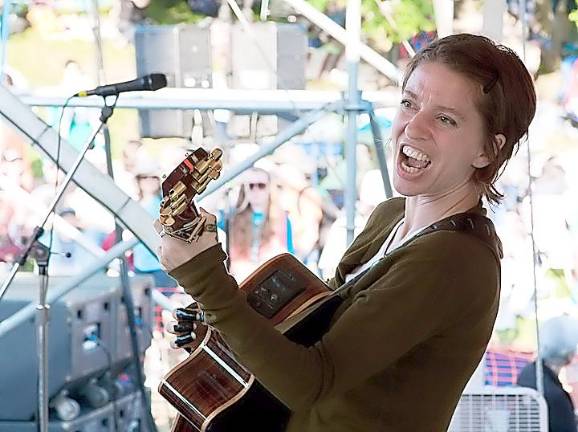 Singer Ani DiFranco performs on the Rainbow Stage at Clearwater Festival several years ago. Photo credit: Econosmith via ClearwaterFestival.org.