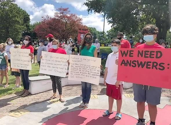 Students and parents protest the Archdiocese of New York’s decision to merge Sacred Heart School with St. John’s in Goshen.