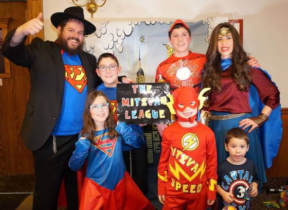 Photos by Michael Hoffman Chabad of Orange County The Burston family, dressed in Superhero costumes with a Jewish twist, welcome guests to the Superhero Purim community party.