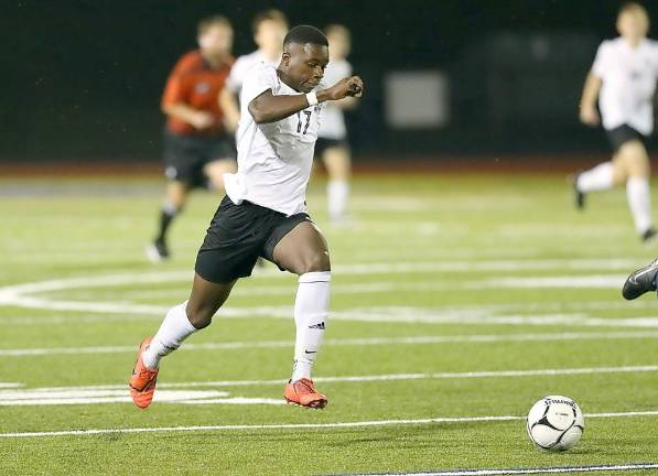 Tenmetey Tetteh-Nartey brings the ball down the field before hitting Jesse Schwartz with a pass.