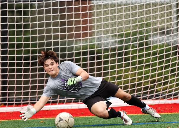 Crusader Goalie Justin Landusky makes a save during warm ups.