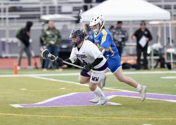 Dominick Cosenza, #6, wins another faceoff for the Crusaders.