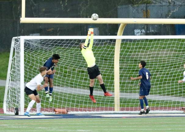 Crusader goalie Parker Giles leaps high in the air to stop a Goldback shot.