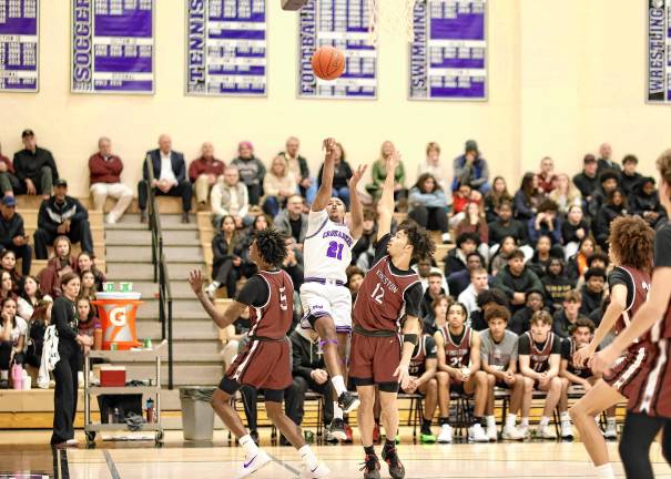 Trayvon McGraw, #21, shoots over a Tiger defender in the first half.
