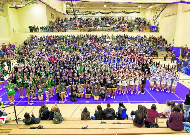 The teams and fans await the final results in the packed Monroe-Woodbury gym.