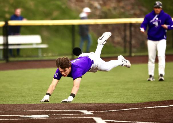 Liam Hayes dives into home with the winning run.
