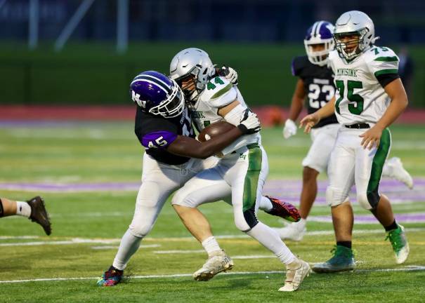 Crusader Kamal Salaudeen, #45, tackles a Warrior running back for a loss.