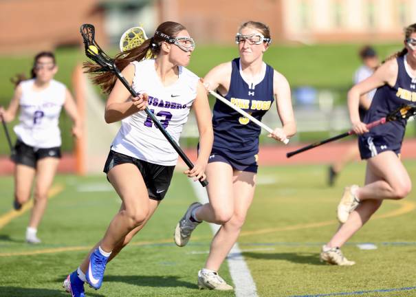 #13, Gianna Pacciarelli moves the ball out of the Crusaders defensive zone.