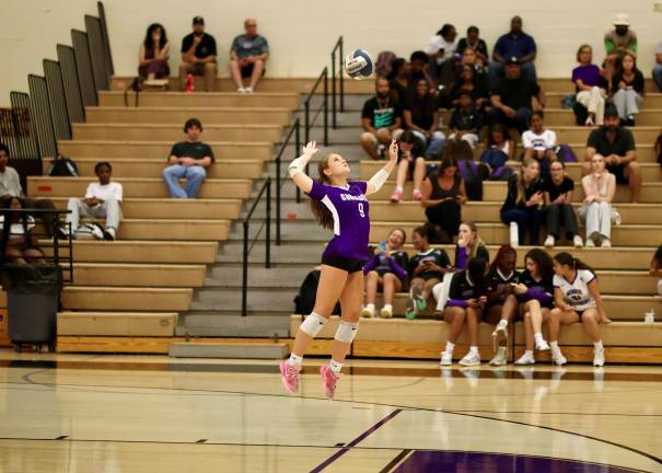 #9, Senior Co Captain Megan Cunniffe serves against the Panthers.
