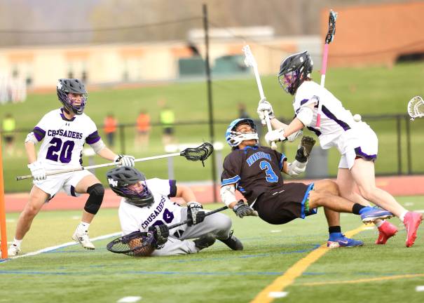 Crusaders defenseman Anthony Schaffer clears the front of the Crusadsers goal with a hard check on a Middie.