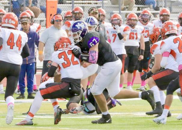 Crusader Michael Pirraglia, #67, finishes his block on a Tiger defender