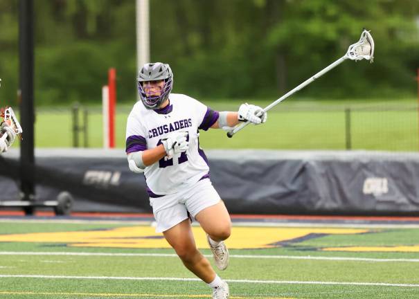 Crusader defenseman Jose Hernandez brings the ball out of the Crusaders zone.