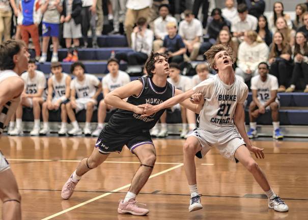 Crusader Charlie Theokas battles an Eagle defender for position under the boards.