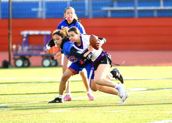 Defensive back Ariana Torrellas #12,picks off a Gladiator pass in the first half.