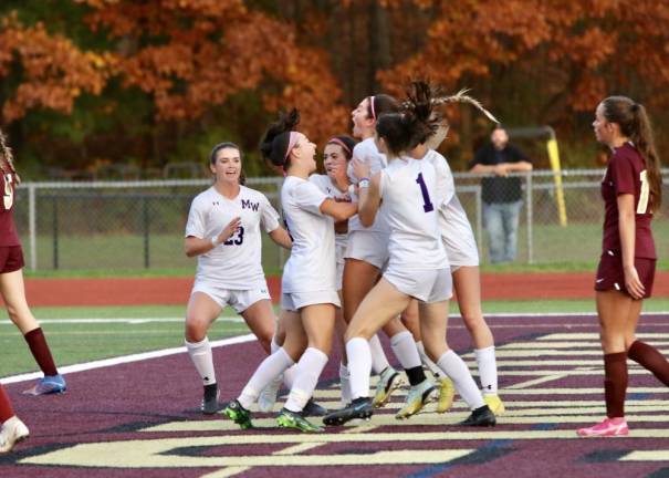 Faith Zollo center celebrates her first half goal that put the Crusaders up 2-1
