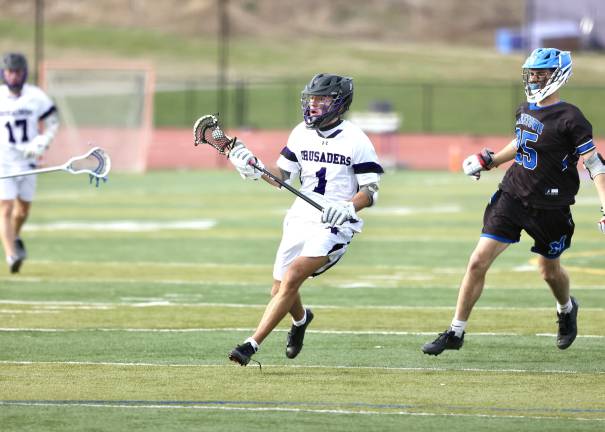 #1, Gavin Fitzgibbon, helped the Crusaders control the game winning 16 of 18 face-offs.