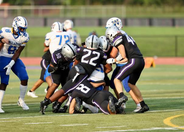 The Crusaders defense swarms over a Wizard ball carrier.