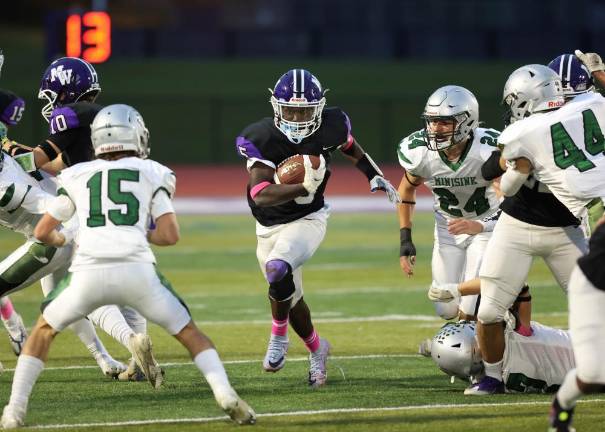 Crusader running back Nate Coulanges, #5, cuts through a hole in the Warriors’ defense.