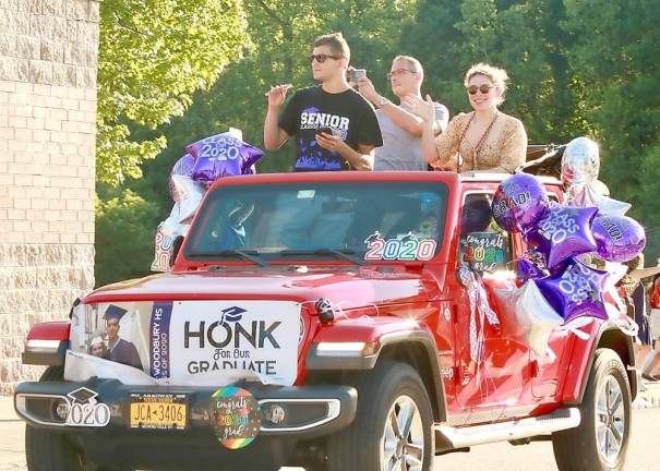 The parade slowly winds its way past the high school.