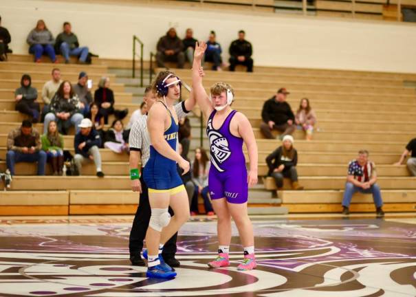 Ashton Capen gets his hand raised by the referee after recording a pin in 2:22.