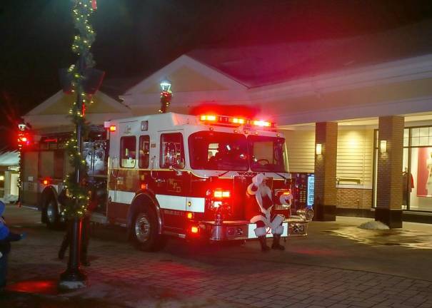 Santa arrived on a Woodbury firetruck.