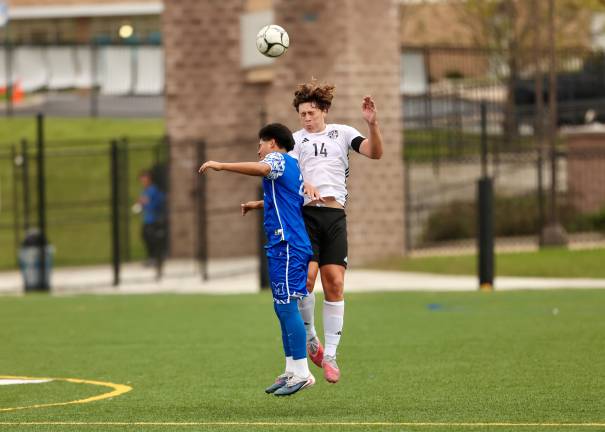 Jayden Scamarone #14 heads a ball near midfield in the game.