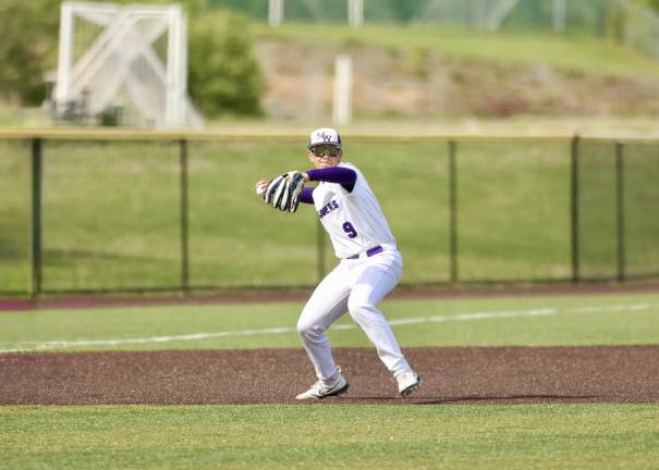 Third baseman Evan Erickson makes the throw to first to nail the Goldback runner