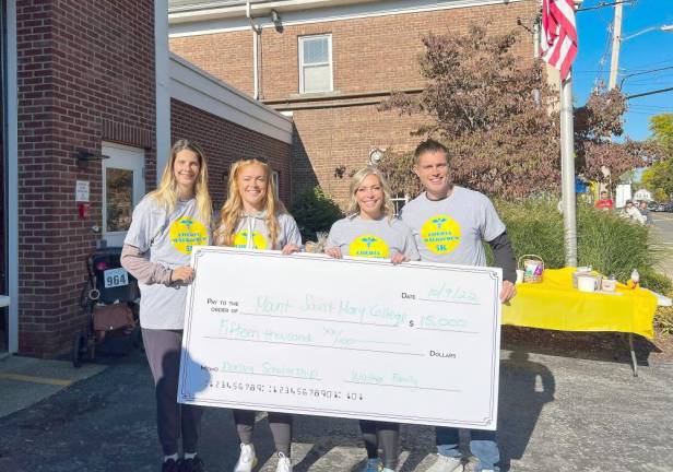 From left to right: Margaret Treacy, director of Annual Giving at the college, and Cheryl’s children: Lindsay Walker, Kristen Antoni, and Matt Walker.