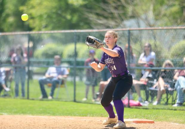 #14, Crusader first baseman Ava Hayes waits for a throw from third base in the second inning.
