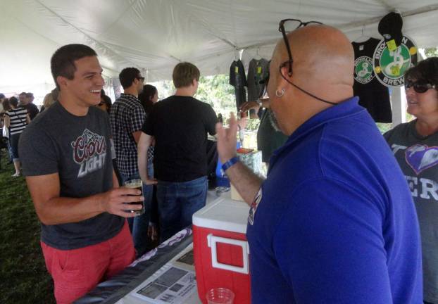 Steven Florkiewicz, of Warwick, gets sample of Newburgh Brewing's brown ale from Charlie Benedetti, part owner of the brewery.