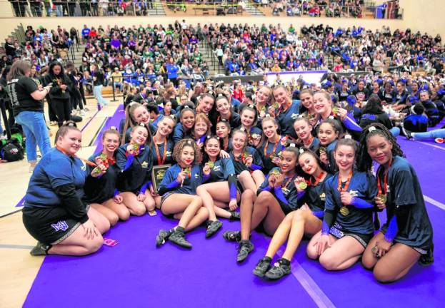 The cheerleaders and head coach Barbara Alidad celebrate their Section 9 title.