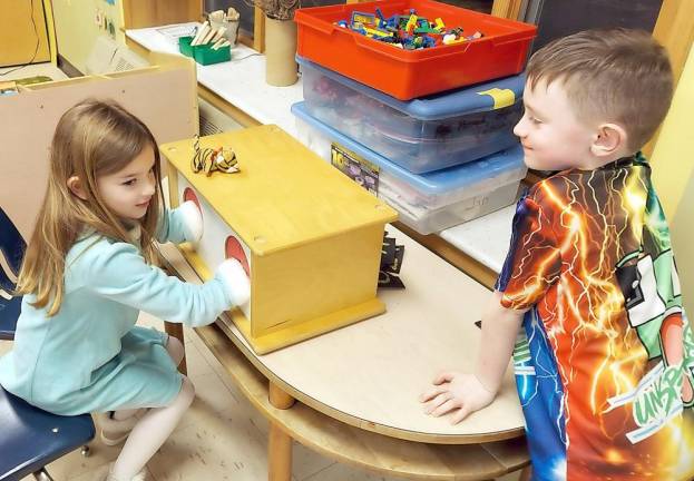 Tori Doyle uses her fingers to recognize a numeral given to her by William Coyle.