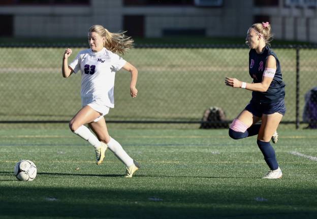 Kyra Gilligan (#23) races past her defender before making a pass too Grace Gillette to put the Crusaders up 1-0.