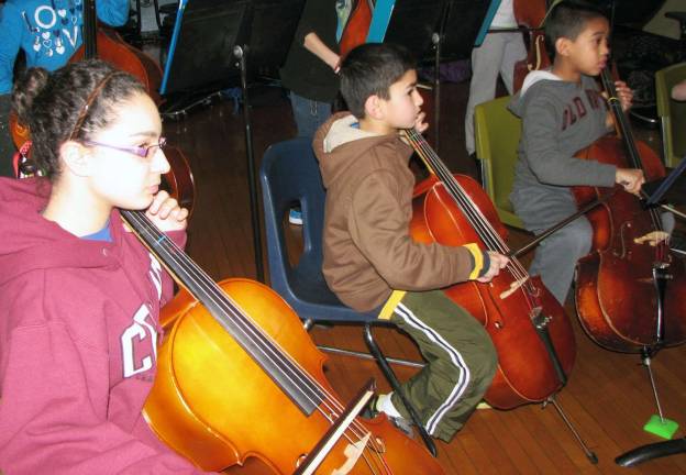 Photo by Nancy Kriz Music mentor cellist Alyssa Sollazzo plays along side North Main cellists Ajraf Mannan, center, and Ben Ibanez.