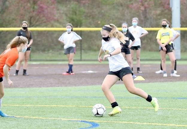 Grace Wanderling tries to move past her defender during a drill at Monroe-Woodbury High School on Monday. Photos by William Dimmit.