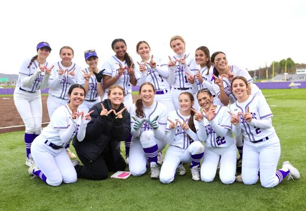 The Crusaders Varsity Softball celebrates their opening day victory over the Middies.