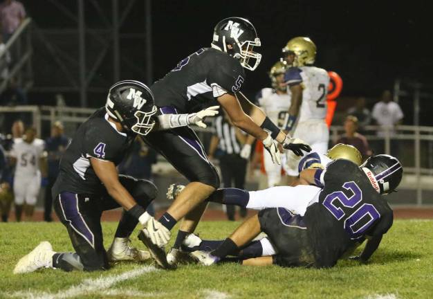 The Crusader defense shutdown the Goldbacks in the second half: Owen Chambers (#20), #5 Jack Colbath (#5) and Matt Seguniot (#4) throw the NFA runner for a loss.